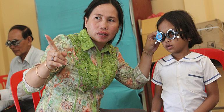 cambodian girl at an eye screening wearing glasses
