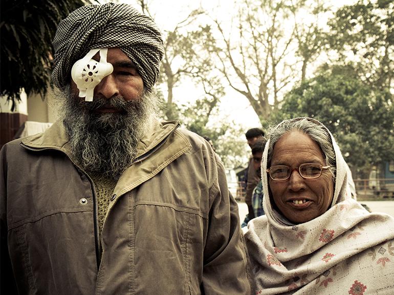 Nepali husband with eye patch and his wife wearing glasses