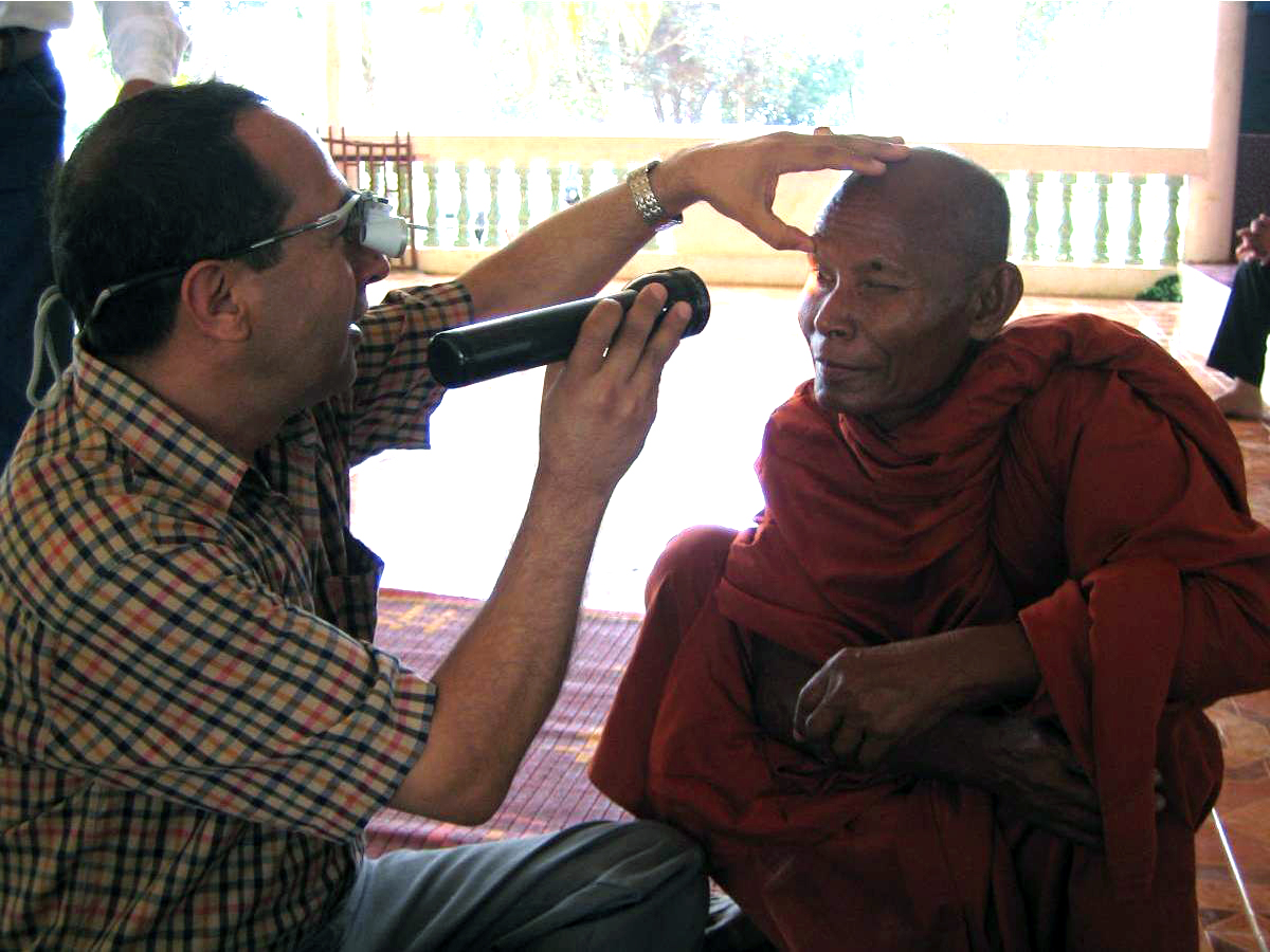 Buddhist monk having his eyes examined by Seva