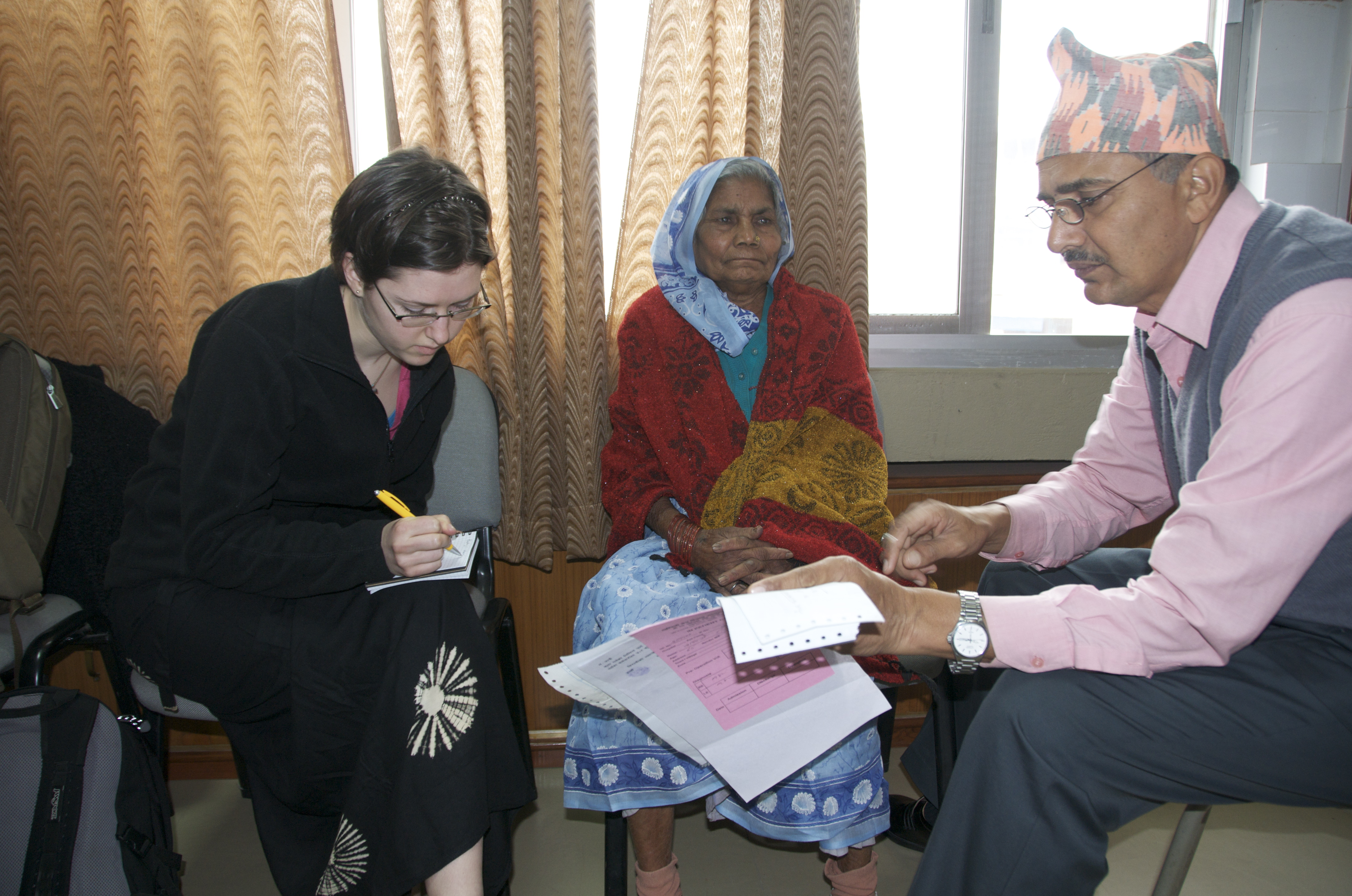 Justine Spencer with Mr. RP Kandel of Seva Nepal, interviewing a cataract patient prior to her surgery
