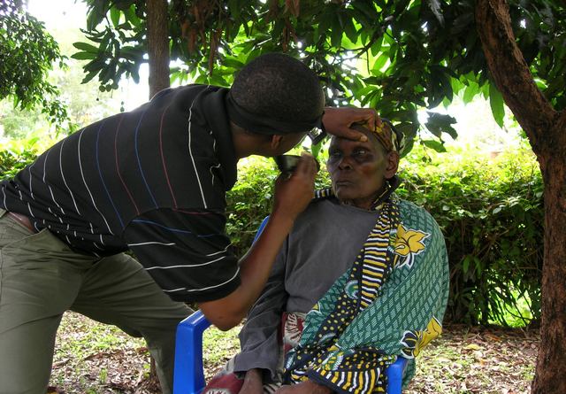 A patient has her eyes examined in Tanzania