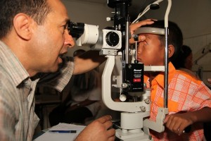 Dr. KC, Seva ophthalmologist, examining a young patient in  Battambang Cambodia