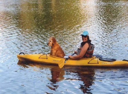 Seva donor Heather Dunbar in a canoe with his dog Max