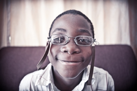 Malawi boy smiling in new glasses