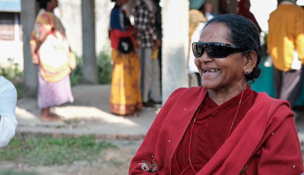 Nepali woman post-op wearing sunglasses and smiling